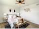 Cozy bedroom with ceiling fan, light gray walls, and a wooden bench at the foot of the bed at 7384 Van Lake Dr, Englewood, FL 34224