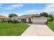 Charming single-story home featuring a well-maintained lawn and a spacious two-car garage at 7384 Van Lake Dr, Englewood, FL 34224