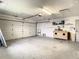 Spacious two-car garage with ample storage shelving and workshop area at 7384 Van Lake Dr, Englewood, FL 34224