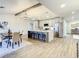 Modern kitchen with an island, stainless steel appliances, and light cabinets at 7384 Van Lake Dr, Englewood, FL 34224