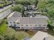 Aerial view of condo building, showing building layout, parking lot, and landscaping at 7816 Hardwick Dr # 1024, New Port Richey, FL 34653