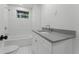 Updated bathroom with gray vanity, subway tile, and a bathtub at 18839 Aripeka Rd, Hudson, FL 34667