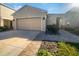 House exterior featuring a two-car garage and landscaped front yard at 6223 Springmont Loop, Palmetto, FL 34221