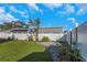 Artificial turf backyard with tropical landscaping and white fence at 1315 Gangplank Dr, Valrico, FL 33594