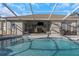 Inviting pool area with covered patio, outdoor furniture, and a tranquil ambiance at 1315 Gangplank Dr, Valrico, FL 33594