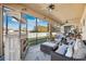 Spacious screened porch with comfortable seating and lake view at 1726 Cameron Court, Trinity, FL 34655