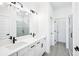 Modern bathroom featuring dual vanities, a glass shower, and contemporary fixtures at 104 Runaway Field Ave, Nokomis, FL 34275