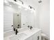 Dual vanity bathroom with modern fixtures and white quartz countertops at 104 Runaway Field Ave, Nokomis, FL 34275