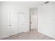 Bedroom with sliding closet doors and wood-look tile floors at 104 Runaway Field Ave, Nokomis, FL 34275