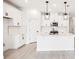 Bright white kitchen featuring an island, stainless steel appliances, and ample storage at 104 Runaway Field Ave, Nokomis, FL 34275
