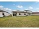 Spacious backyard with a covered patio and green lawn at 117 Runaway Field Ave, Nokomis, FL 34275
