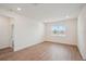 Bright bedroom with wood-look tile floors and a large window at 117 Runaway Field Ave, Nokomis, FL 34275