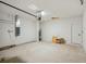 Two-car garage with white painted block walls, concrete floor, and garage door opener at 117 Runaway Field Ave, Nokomis, FL 34275