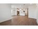 Open-concept living area with wood-look tile flooring and a view of the kitchen at 117 Runaway Field Ave, Nokomis, FL 34275