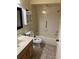 Bathroom with tub, toilet, vanity, and wall-mounted cabinet at 2513 Lancaster Dr, Sun City Center, FL 33573