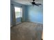 Well-lit bedroom with neutral walls and carpet at 2513 Lancaster Dr, Sun City Center, FL 33573