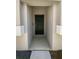 Modern house entrance with a black front door and neutral colored exterior at 17827 Turning Leaf Cir, Land O Lakes, FL 34638