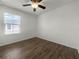 Bright bedroom featuring wood flooring and a window at 8863 White Sage Loop, Lakewood Ranch, FL 34202