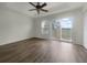 Spacious bedroom with wood flooring and sliding glass doors to balcony at 8863 White Sage Loop, Lakewood Ranch, FL 34202