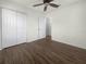 Simple bedroom with wood-look flooring, large closet, and neutral walls at 8863 White Sage Loop, Lakewood Ranch, FL 34202