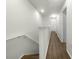 Long hallway with wood flooring and access to bedrooms at 8863 White Sage Loop, Lakewood Ranch, FL 34202