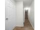 Bright hallway with wood flooring leading to staircase at 8863 White Sage Loop, Lakewood Ranch, FL 34202