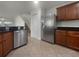 Stainless steel appliances and wood cabinetry in kitchen at 8863 White Sage Loop, Lakewood Ranch, FL 34202