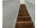 Modern stairs with dark wood steps and white railings at 8863 White Sage Loop, Lakewood Ranch, FL 34202