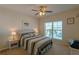 Bedroom with white bed frame, ceiling fan, and window at 3919 Cape Haze Dr # 503, Rotonda West, FL 33947