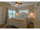 Bedroom with white bed frame, ceiling fan, and ocean decor at 3919 Cape Haze Dr # 503, Rotonda West, FL 33947