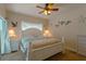 Bedroom with white bed frame, ceiling fan, and ocean decor at 3919 Cape Haze Dr # 503, Rotonda West, FL 33947