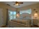 Bedroom with white bed frame, ceiling fan, and ocean decor at 3919 Cape Haze Dr # 503, Rotonda West, FL 33947