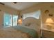 Bright bedroom with a queen-size bed, and sliding door to balcony at 3919 Cape Haze Dr # 503, Rotonda West, FL 33947