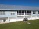 Rear exterior view showing screened porch, patio, and AC units at 3919 Cape Haze Dr # 503, Rotonda West, FL 33947