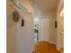 Bright hallway with hardwood floors, leading to bedroom and bathroom at 3919 Cape Haze Dr # 503, Rotonda West, FL 33947