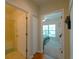 Hallway with doors to bathroom and bedroom, hardwood floors, and linen closet at 3919 Cape Haze Dr # 503, Rotonda West, FL 33947