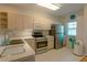 Modern kitchen featuring stainless steel appliances and light wood cabinets at 3919 Cape Haze Dr # 503, Rotonda West, FL 33947