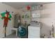 Laundry room with washer, dryer, and storage shelves at 3919 Cape Haze Dr # 503, Rotonda West, FL 33947