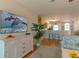 Living room with comfy seating, a large TV, and a view into the kitchen at 3919 Cape Haze Dr # 503, Rotonda West, FL 33947