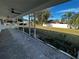 Covered back patio overlooking a spacious fenced yard and lush landscaping at 6370 Conniewood Sq, New Port Richey, FL 34653