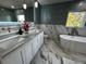 Modern bathroom featuring a soaking tub, dual sinks, and stylish marble and tile finishes at 6370 Conniewood Sq, New Port Richey, FL 34653