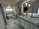 Luxurious bathroom featuring double sinks, a soaking tub, and contemporary finishes for a spa-like experience at 6370 Conniewood Sq, New Port Richey, FL 34653
