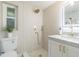 Elegant bathroom with a rainfall shower head, a window for natural light, and a modern sink at 6370 Conniewood Sq, New Port Richey, FL 34653