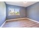 Bright, airy bedroom with modern flooring and a large window offering plenty of natural light at 6370 Conniewood Sq, New Port Richey, FL 34653
