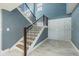 Welcoming entryway featuring a staircase with modern railing and tile floors at 6370 Conniewood Sq, New Port Richey, FL 34653