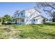 Expansive two-story home features a wraparound porch and large yard, perfect for outdoor enjoyment at 6370 Conniewood Sq, New Port Richey, FL 34653