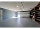 Spacious two-car garage with overhead lighting, shelving for storage, and an automatic door for convenience at 6370 Conniewood Sq, New Port Richey, FL 34653