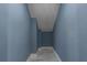 Hallway with blue walls, white trim, and tile floors at 6370 Conniewood Sq, New Port Richey, FL 34653