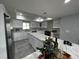 Open kitchen with white cabinets, stainless steel appliances, marble countertops, and a large island at 6370 Conniewood Sq, New Port Richey, FL 34653
