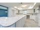Modern kitchen with white cabinets, marble countertops, and stainless steel appliances at 6370 Conniewood Sq, New Port Richey, FL 34653
